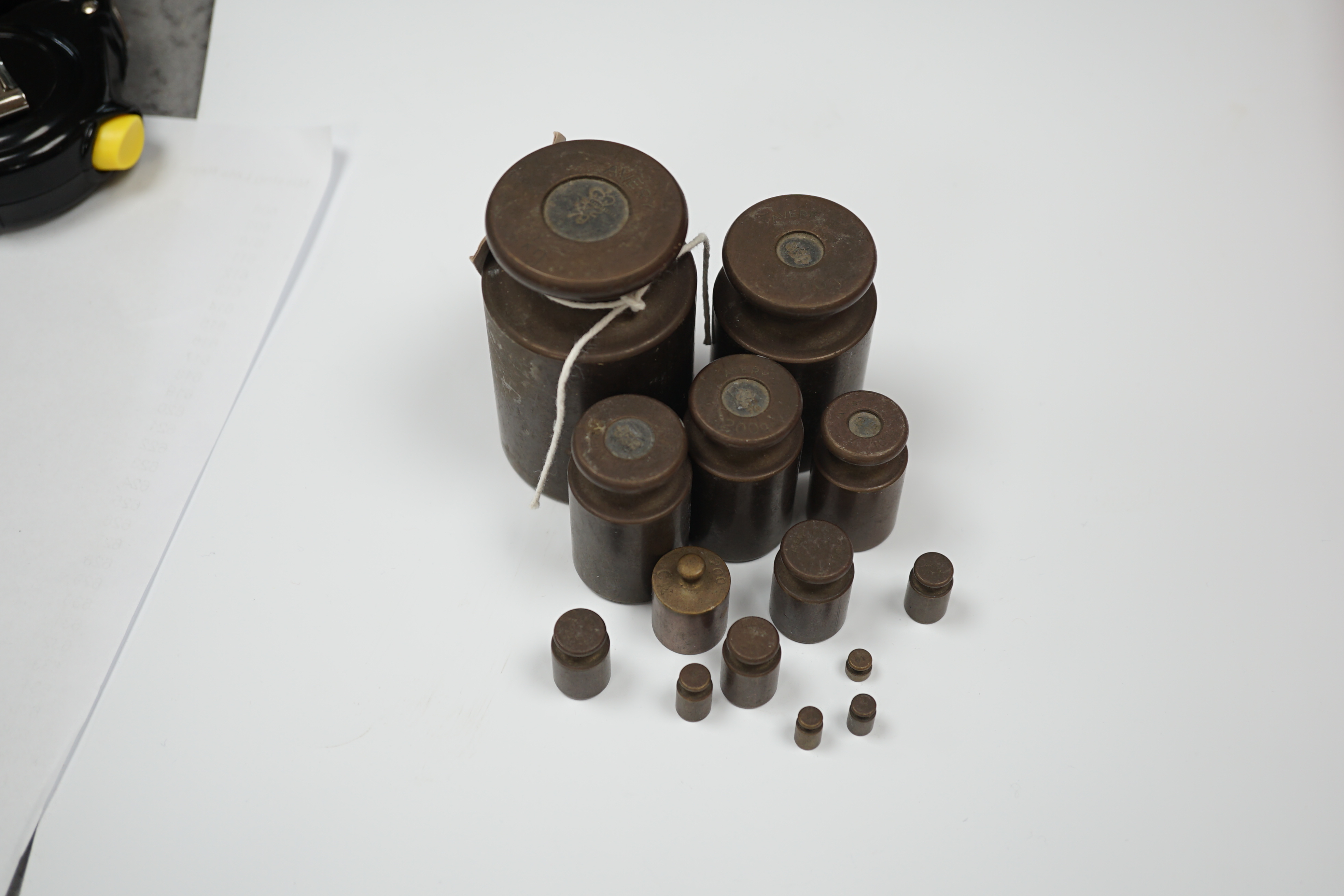 A set of fourteen graduated Avery weights, largest 8cm high